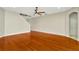 Bright living room with hardwood floors, staircase, and a ceiling fan at 502 Arch Ridge Loop, Seffner, FL 33584