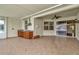 Large covered patio featuring tile flooring, a built-in kitchen area, and seamless indoor-outdoor living at 502 Arch Ridge Loop, Seffner, FL 33584