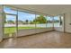 Screened patio with tile floor and view of fenced backyard and green space at 502 Arch Ridge Loop, Seffner, FL 33584