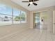 Sun room with tiled floors and windows overlooking the yard at 502 Arch Ridge Loop, Seffner, FL 33584