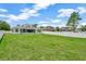 Expansive backyard showcasing a well-maintained lawn and secure white fencing, offering privacy and space at 502 Arch Ridge Loop, Seffner, FL 33584