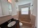 Well-lit bathroom features a tub and shower combination and a sink with black countertop at 6081 22Nd N Ave, St Petersburg, FL 33710