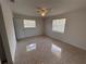 This bedroom has terrazzo flooring and natural light from dual windows at 6081 22Nd N Ave, St Petersburg, FL 33710