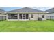 View of the backyard with the screened-in patio at 6226 165Th E Dr, Parrish, FL 34219