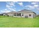 Expansive backyard with green grass and a view of the home's exterior at 6226 165Th E Dr, Parrish, FL 34219