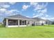 Spacious backyard featuring a screened patio and lush green grass at 6226 165Th E Dr, Parrish, FL 34219