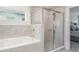 Beautiful bathroom with a tub, shower, and tiled walls at 6226 165Th E Dr, Parrish, FL 34219