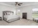 Spacious bedroom featuring a large bed, ceiling fan, and natural light at 6226 165Th E Dr, Parrish, FL 34219