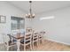 Bright dining room featuring a wood table, white chairs, and natural light at 6226 165Th E Dr, Parrish, FL 34219