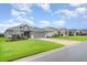 Street view of a well-maintained single-story house with a grey exterior and manicured landscaping at 6226 165Th E Dr, Parrish, FL 34219