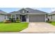 Charming single-story home featuring a well-manicured lawn and a two-car garage at 6226 165Th E Dr, Parrish, FL 34219