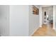 Bright hallway featuring light wood floors and neutral paint, leading to the living area at 6226 165Th E Dr, Parrish, FL 34219