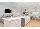 Modern kitchen with white cabinets, a large island, and an open layout to the living area at 6226 165Th E Dr, Parrish, FL 34219