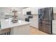 Modern kitchen with stainless steel appliances and white cabinetry and a large island at 6226 165Th E Dr, Parrish, FL 34219