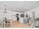 Open-concept kitchen with white cabinets, stainless steel appliances, and a breakfast bar at 6226 165Th E Dr, Parrish, FL 34219