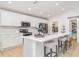 Bright kitchen featuring a large island with seating, stainless steel appliances, and ample cabinet space at 6226 165Th E Dr, Parrish, FL 34219