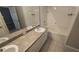 Bright bathroom with tile flooring, double vanity sinks, a tub, and neutral walls at 6517 Summer Cove Dr, Riverview, FL 33578