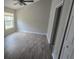 Bedroom with luxury vinyl plank flooring, neutral walls, a ceiling fan, and a large window at 6517 Summer Cove Dr, Riverview, FL 33578