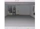 A clean, empty two car garage provides ample room for vehicles, storage, and hobbies at 6517 Summer Cove Dr, Riverview, FL 33578