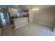 Well-lit kitchen featuring tile flooring, stainless steel refrigerator, modern white cabinets, and breakfast bar at 6517 Summer Cove Dr, Riverview, FL 33578