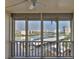 View from the screened-in balcony overlooking the harbor, landscaping, and parking at 7400 Sun Island S Dr # 412, South Pasadena, FL 33707