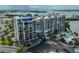 Full exterior of condo building showing updated facade, landscaping, and pool at 7400 Sun Island S Dr # 412, South Pasadena, FL 33707