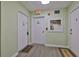 Hallway with unit entrance and emergency equipment access, showing a secure and safe building at 7400 Sun Island S Dr # 412, South Pasadena, FL 33707