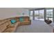 View of the living room featuring a comfortable sofa and a picturesque view of the water at 7400 Sun Island S Dr # 412, South Pasadena, FL 33707