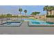 Outdoor pool and hot tub surrounded by lounge chairs and landscaping for ultimate relaxation at 7400 Sun Island S Dr # 412, South Pasadena, FL 33707