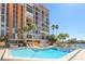 Resort-style pool and deck with lounge seating and palm trees at the base of the building at 7400 Sun Island S Dr # 412, South Pasadena, FL 33707