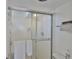 Shower with white tile and sliding glass door at 7400 Sun Island S Dr # 412, South Pasadena, FL 33707