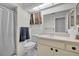 Bright bathroom featuring a toilet, single sink vanity, mirror, and shower/tub combination at 7708 Fairlawn Dr, Hudson, FL 34667