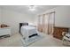 Cozy bedroom features a bed, ceiling fan, and window with natural light at 7708 Fairlawn Dr, Hudson, FL 34667