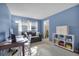 Bright bedroom features a gray sofa, work desk, and natural lighting at 7708 Fairlawn Dr, Hudson, FL 34667