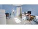 Bright bedroom features a work desk, natural lighting, and blue walls at 7708 Fairlawn Dr, Hudson, FL 34667