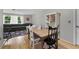 Cozy dining area adjacent to the living room, featuring wood floors and a wooden dining table at 7708 Fairlawn Dr, Hudson, FL 34667