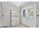 Bright entryway features a white hutch, tiled floors, and a door with window for natural light at 7708 Fairlawn Dr, Hudson, FL 34667