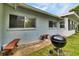 Exterior view of the home featuring windows, a grill and a blue exterior paint color at 7708 Fairlawn Dr, Hudson, FL 34667