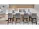 Open kitchen area with a long island and four stools at 7708 Fairlawn Dr, Hudson, FL 34667