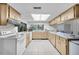 Spacious kitchen featuring wood cabinets, white appliances, and ample counter space at 7708 Fairlawn Dr, Hudson, FL 34667