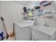 Laundry room features a sink, washer, dryer, and storage shelves at 7708 Fairlawn Dr, Hudson, FL 34667