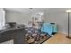 Open floor plan living room with plush gray sectional sofa, decorative rug, and a view to dining area at 7708 Fairlawn Dr, Hudson, FL 34667