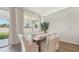 Bright dining area with large windows, contemporary furnishings, and elegant decor at 7747 Wheat Stone Dr, Zephyrhills, FL 33540