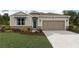 Charming single-Gathering home with a landscaped front yard and a two-car garage at 7747 Wheat Stone Dr, Zephyrhills, FL 33540
