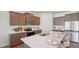 Stylish kitchen with stainless steel appliances, an island with seating, and modern countertops at 7747 Wheat Stone Dr, Zephyrhills, FL 33540
