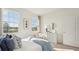 Bright main bedroom with large windows, comfortable bedding, and stylish decor at 7747 Wheat Stone Dr, Zephyrhills, FL 33540