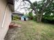 Backyard featuring a shed and plenty of grassy space, perfect for outdoor activities and storage at 8718 N Brooks St, Tampa, FL 33604