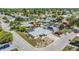 Aerial view of home featuring a new roof, solar panels, patio, and lush landscaping in a quiet neighborhood at 9115 Panda Ln, Port Richey, FL 34668