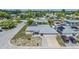 Aerial view of home featuring a new roof, solar panels, patio, and lush landscaping in a quiet neighborhood at 9115 Panda Ln, Port Richey, FL 34668