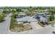 Aerial view of home featuring a new roof, solar panels, patio, and lush landscaping in a quiet neighborhood at 9115 Panda Ln, Port Richey, FL 34668